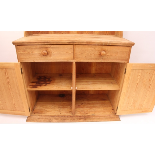 457 - A waxed-pine Victorian-style dresser of compact proportions - the top section with wavy sides and th... 