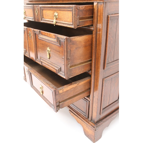 465 - A late-17th century panelled oak chest of drawers - the three-plank top over four panel sides and fo... 