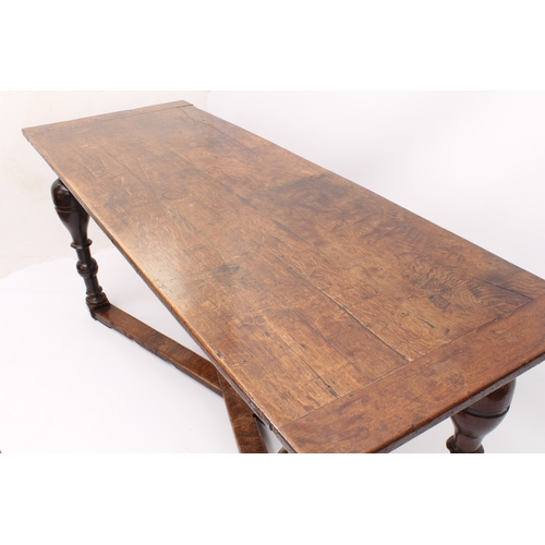 466 - A narrow oak refectory table in early 18th century style -  later constructed, using some earlier el... 