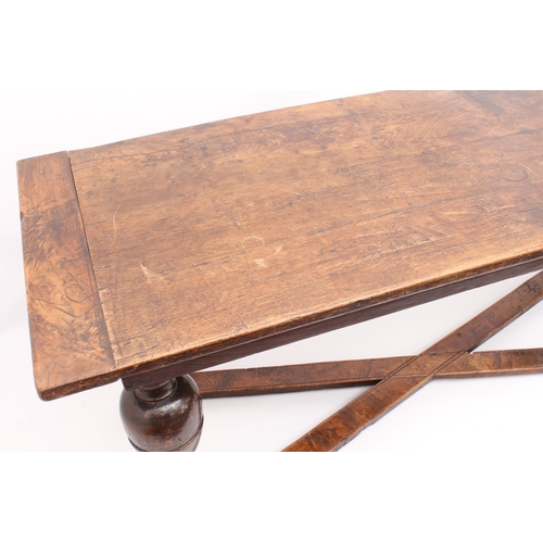 466 - A narrow oak refectory table in early 18th century style -  later constructed, using some earlier el... 