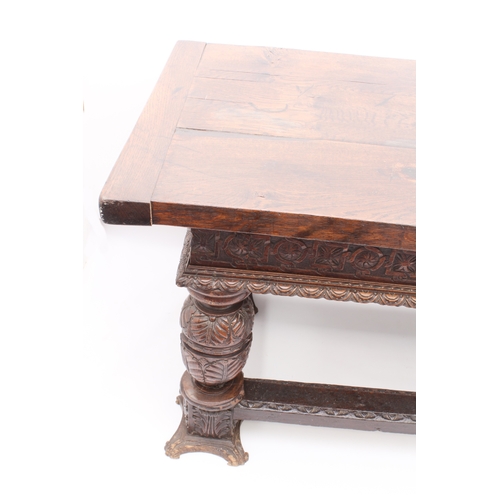 470 - An Elizabethan-style carved oak refectory table - 20th century, the three-plank, cleated top over a ... 