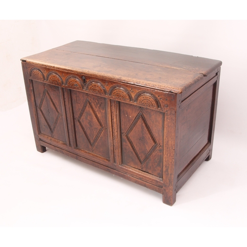 473 - An early 18th century oak three panel coffer - the two plank lid on later hinges, over a front with ... 