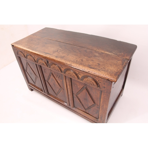 473 - An early 18th century oak three panel coffer - the two plank lid on later hinges, over a front with ... 