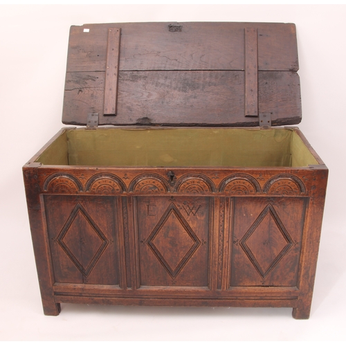 473 - An early 18th century oak three panel coffer - the two plank lid on later hinges, over a front with ... 