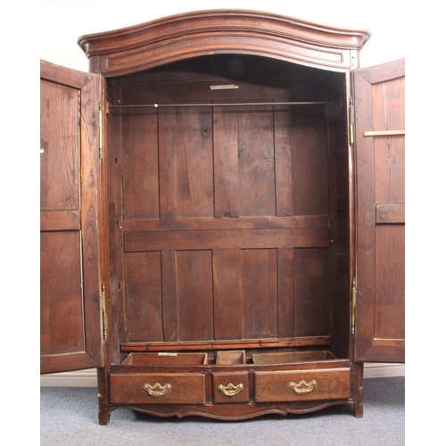 479 - A large early 19th century French chestnut armoire – serpentine arched cornice and frieze over twin ... 