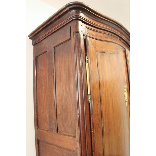 479 - A large early 19th century French chestnut armoire – serpentine arched cornice and frieze over twin ... 