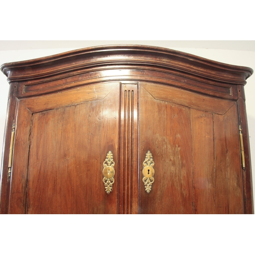 479 - A large early 19th century French chestnut armoire – serpentine arched cornice and frieze over twin ... 