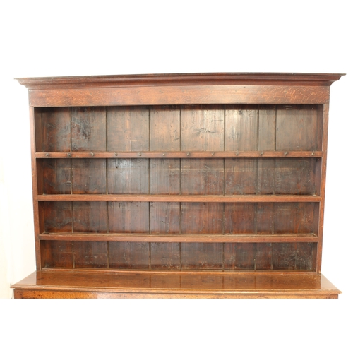 480 - A mid-18th century oak potboard dresser - the ogee cornice over a closed plate-rack with three shelv... 