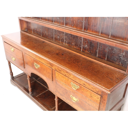 480 - A mid-18th century oak potboard dresser - the ogee cornice over a closed plate-rack with three shelv... 