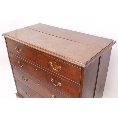 488 - A George III oak straight front chest of drawers - the ogee moulded top over two short and three lon... 