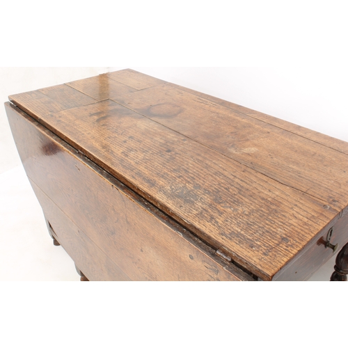 489 - An early 18th century and later joined oak dropflap dining table - the oval top with alterations, op... 