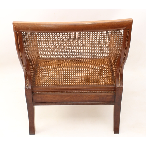 492 - A Regency mahogany and leather bergère - the reeded rectangular scrolled back over swept reeded arms... 