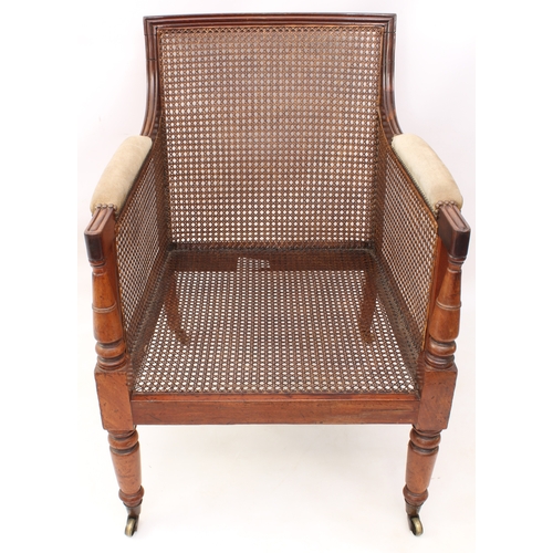 494 - A Regency mahogany and suede bergère - the rectangular back over moulded, downswept arms and a loose... 