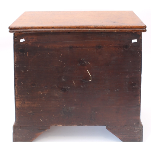 498 - A mid-18th century oak bachelor's chest - the rectangular fold-over top opening on lopers, lined wit... 