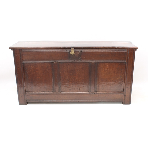 502 - A late 17th century boarded oak chest - of generous proportions, the two-plank top with chip carved ... 