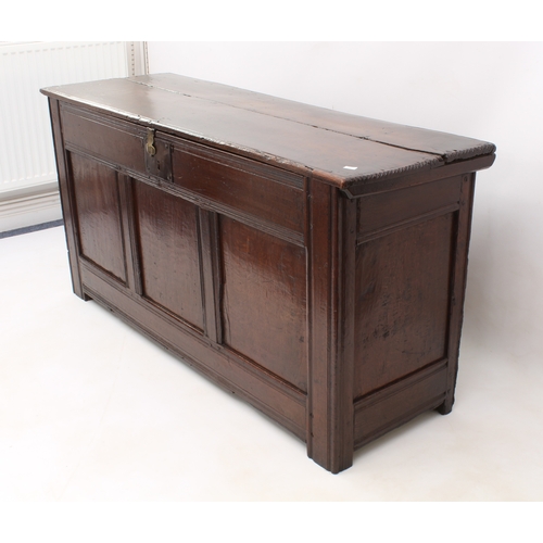 502 - A late 17th century boarded oak chest - of generous proportions, the two-plank top with chip carved ... 