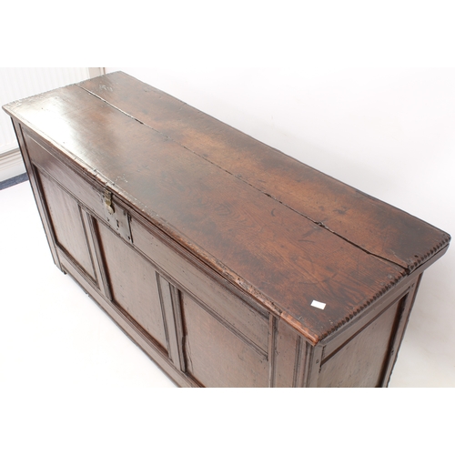 502 - A late 17th century boarded oak chest - of generous proportions, the two-plank top with chip carved ... 