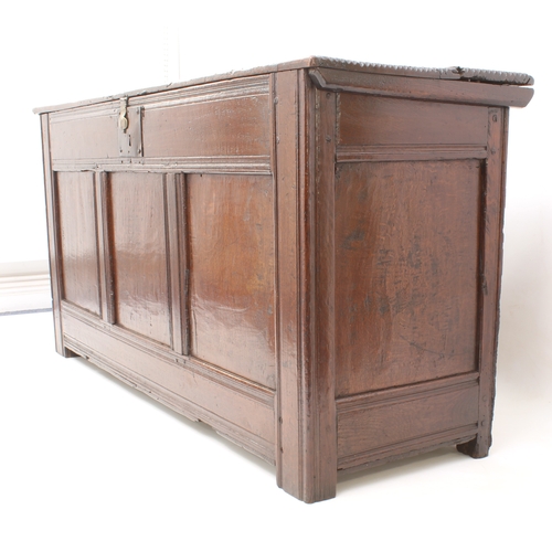 502 - A late 17th century boarded oak chest - of generous proportions, the two-plank top with chip carved ... 