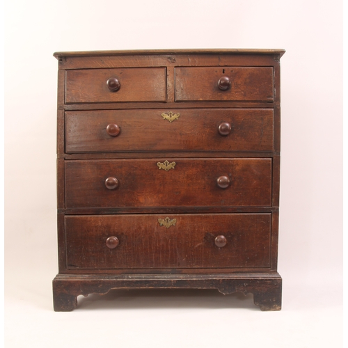 510 - An 18th century oak chest of drawers - the boarded oak top with later edge moulding, over three-pane... 