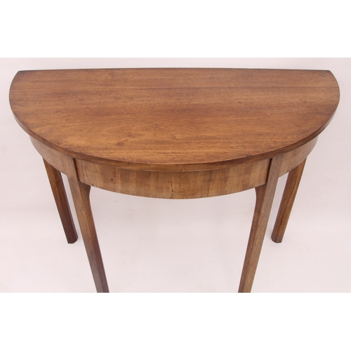 513 - An early 19th century mahogany demi-lune side table - raised on four square chamfered supports. (LWH... 