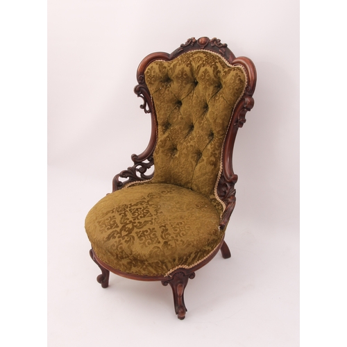 517 - A Victorian carved walnut showframe lady's chair - the frame with a buttoned spoon back, carved and ... 