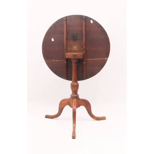 518 - A George III oak tilt-top tripod table - the circular top on a turned gun-barrel column to three swe... 