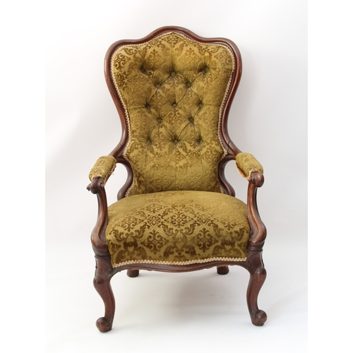 520 - A Victorian showframe carved walnut armchair - the buttoned, trefoil spoon back over padded scroll-c... 