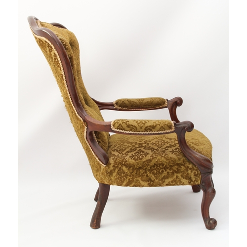 520 - A Victorian showframe carved walnut armchair - the buttoned, trefoil spoon back over padded scroll-c... 