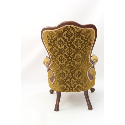 520 - A Victorian showframe carved walnut armchair - the buttoned, trefoil spoon back over padded scroll-c... 