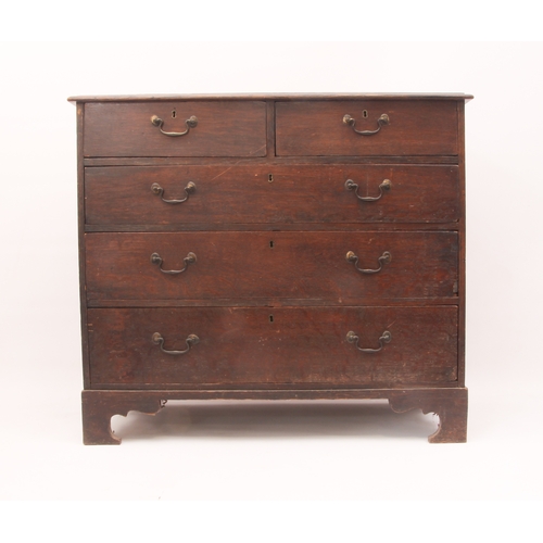 522 - A George III provincial oak straight-front chest of drawers - the moulded top over two short and thr... 