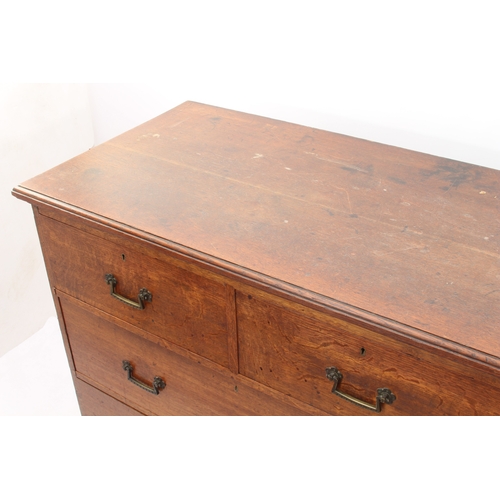 524 - A Victorian oak chest of drawers - the moulded top over two short and two long graduated drawers wit... 