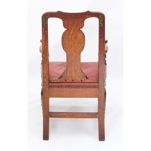 531 - A late 19th century carved oak open armchair - the shaped top rail and uprights carved with fern lea... 