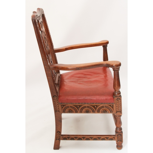 531 - A late 19th century carved oak open armchair - the shaped top rail and uprights carved with fern lea... 