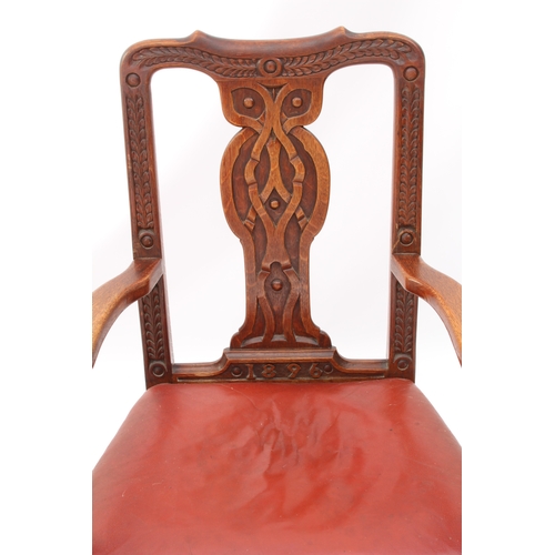 531 - A late 19th century carved oak open armchair - the shaped top rail and uprights carved with fern lea... 