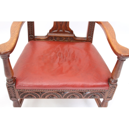 531 - A late 19th century carved oak open armchair - the shaped top rail and uprights carved with fern lea... 