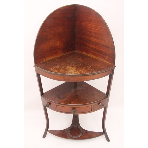 534 - A Regency mahogany corner washstand - with a peaked back over a solid top shelf and ebony-strung und... 