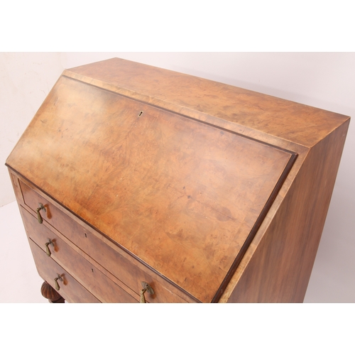 544 - A 1930s burr walnut bureau with mechanical interior mechanism - the quarter veneered fall opening to... 