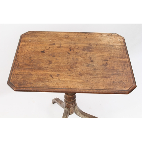 549 - A George III mahogany tilt-top tripod table - the moulded rectangular top with clipped corners, on a... 