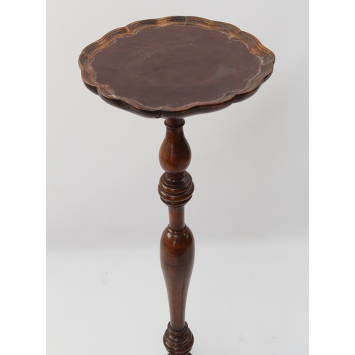 554 - A Georgian-style walnut lamp-stand or torchère - 1930s, the shaped, dished top with inset leather, o... 