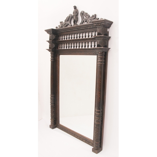 568 - A Northern European carved oak pier mirror - c.1900, the bevelled rectangular plate within a frame w... 