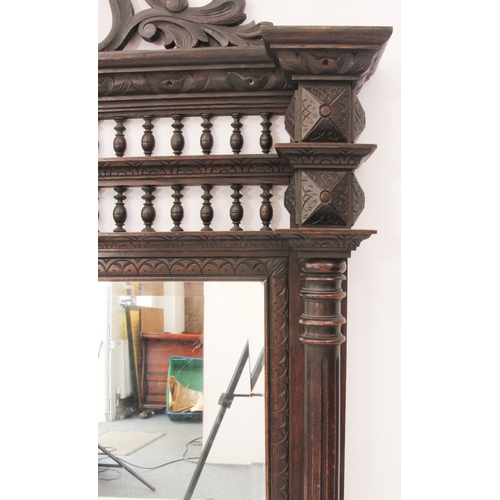 568 - A Northern European carved oak pier mirror - c.1900, the bevelled rectangular plate within a frame w... 