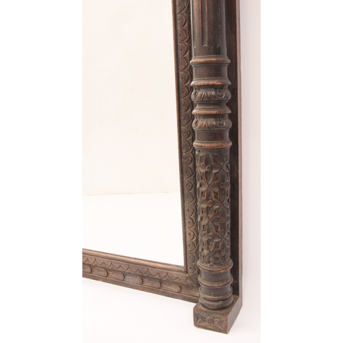 568 - A Northern European carved oak pier mirror - c.1900, the bevelled rectangular plate within a frame w... 