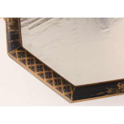 569 - An early 20th century chinoiserie lacquered mirror - octagonal form, with bevelled plate and black l... 