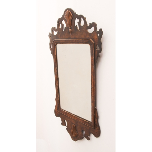 571 - A walnut and parcel-gilt fretwork mirror in George I style - probably 19th century, with gilt shell ... 