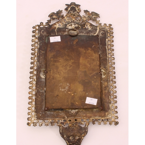 574 - A small cast brass mirror in the Baroque style - late 19th century, the pierced frame with stylised ... 