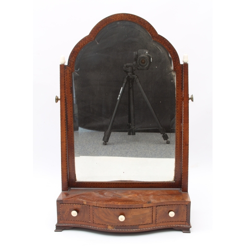 576 - A George III crossbanded mahogany serpentine box-base toilet mirror - the arched, bevelled plate on ... 