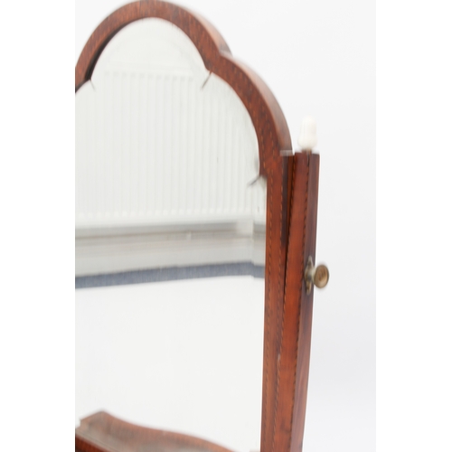 576 - A George III crossbanded mahogany serpentine box-base toilet mirror - the arched, bevelled plate on ... 