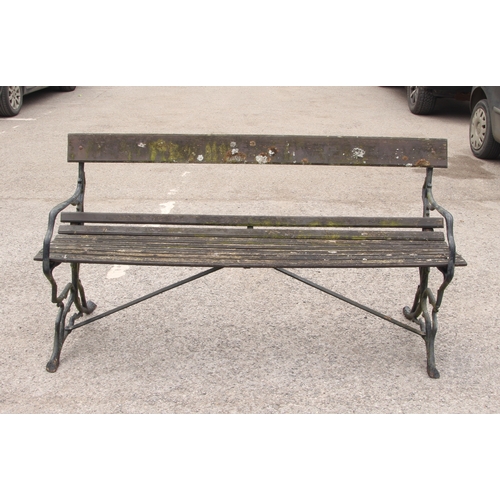 602 - A Victorian-style cast metal and teak garden bench - with branch style scrolled end supports, 153cm ... 