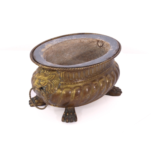 673 - A 19th century style pressed brass jardinière - French, early 20th century, bombé oval form with gad... 