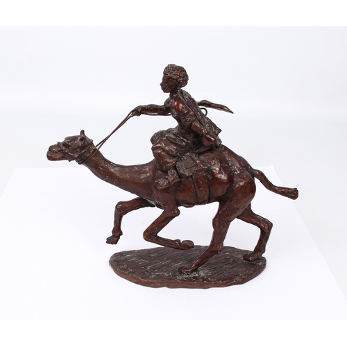 696 - A modern bronze figure of a camel rider - indistinctly signed, with red-brown patination, 23.5cm hig... 